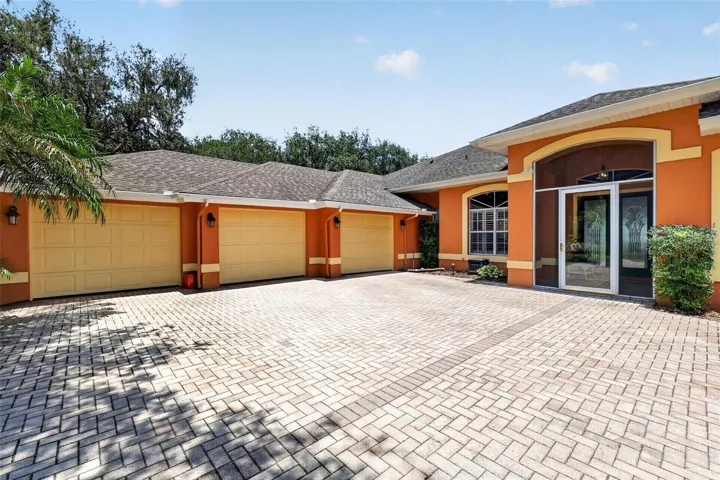 3 car garage, enclosed front porch, brick driveway