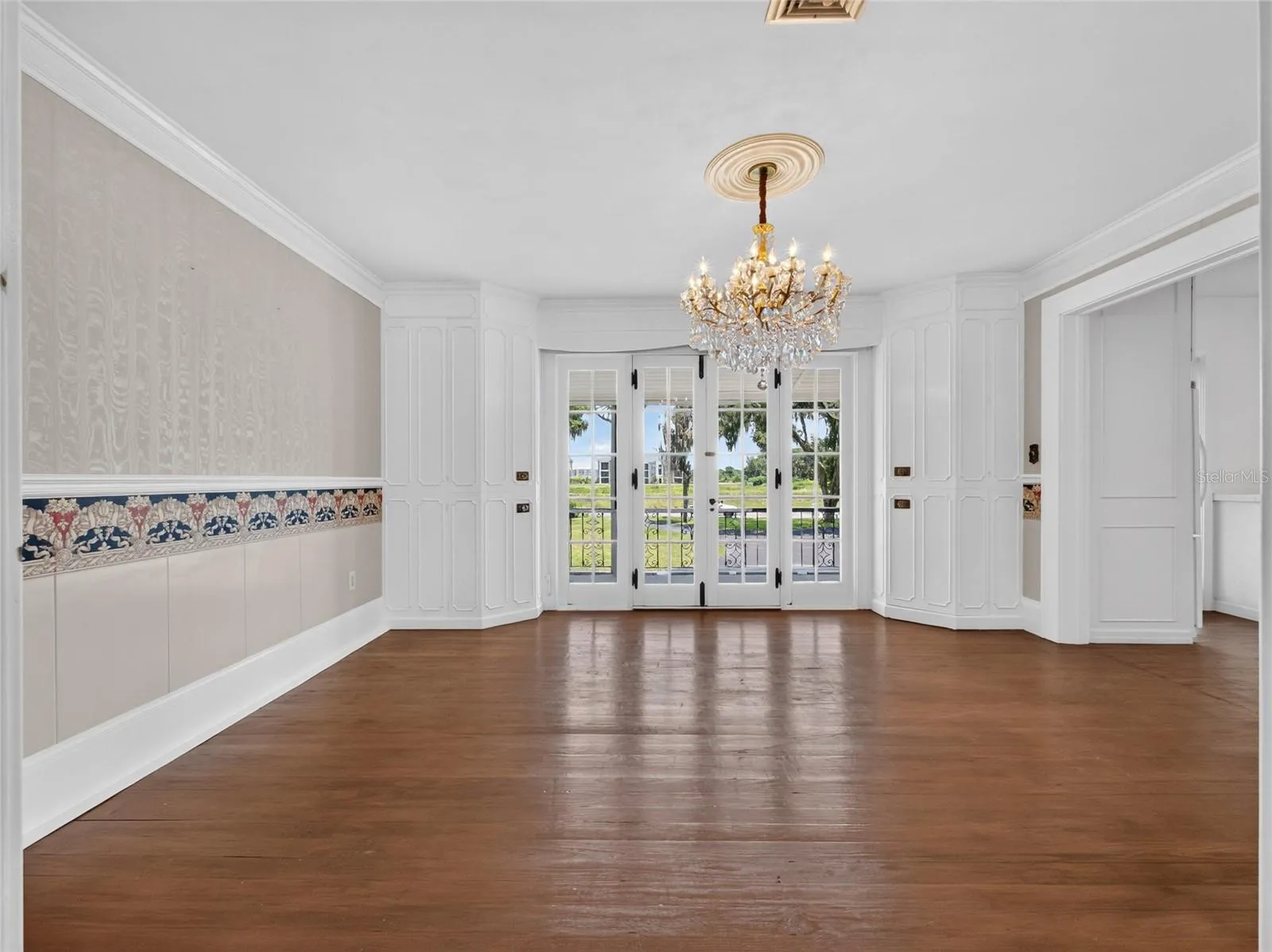 Formal Dining Room with french doors to balcony and built in cabinets.