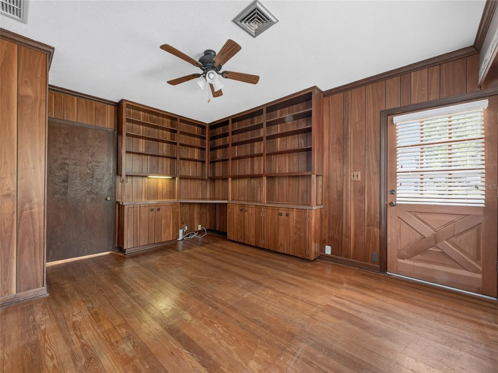 Dedicated Office with built in cabinets and exterior door.