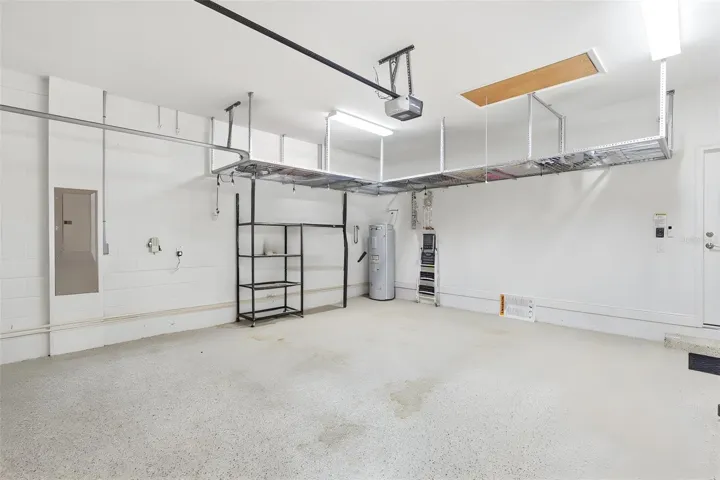 Garage features epoxy floors, ceiling Smart Rack system and garage door screen