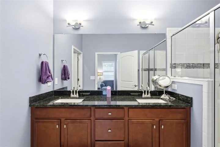 Primary bathroom features dual sink vanity