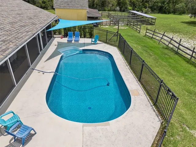 Private pool with screened lanai, fenced backyard area, sunset views and outdoor living space.
