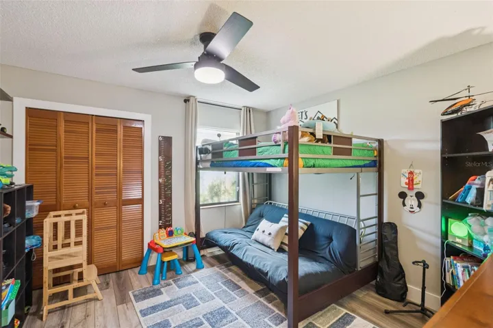 Secondary bedroom with ceiling fan, closet space, and flexible use for guests, family, or office needs.