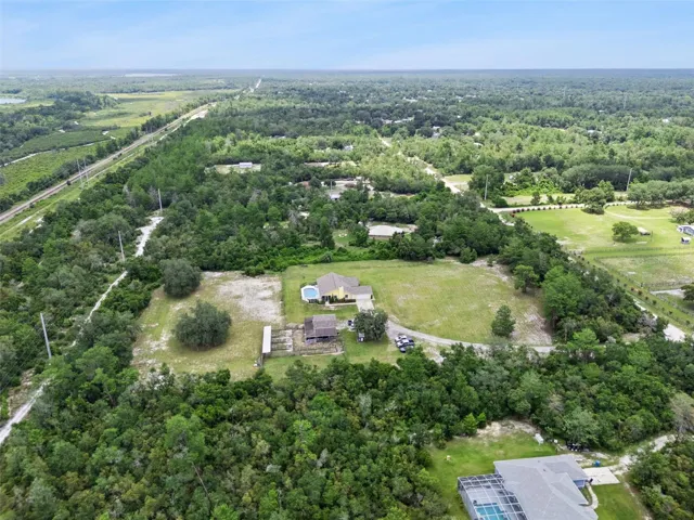 High aerial location view showing the property’s placement near natural areas and the Spring-to-Spring Trail.