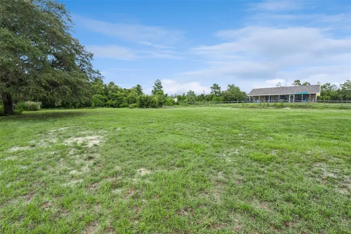 Open fenced land offering space for animals, hobbies, recreation, or future outdoor use.