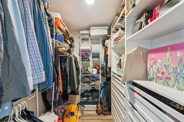 Walk-in closet with built-in shelving and organized storage space.