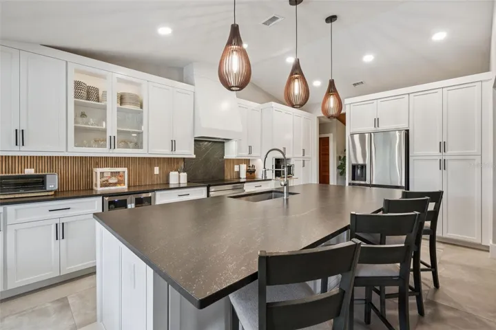 Completely remodeled kitchen with solid wood cabinets, leather-finished granite, stainless appliances, and island workspace and storage in island cabinets.
