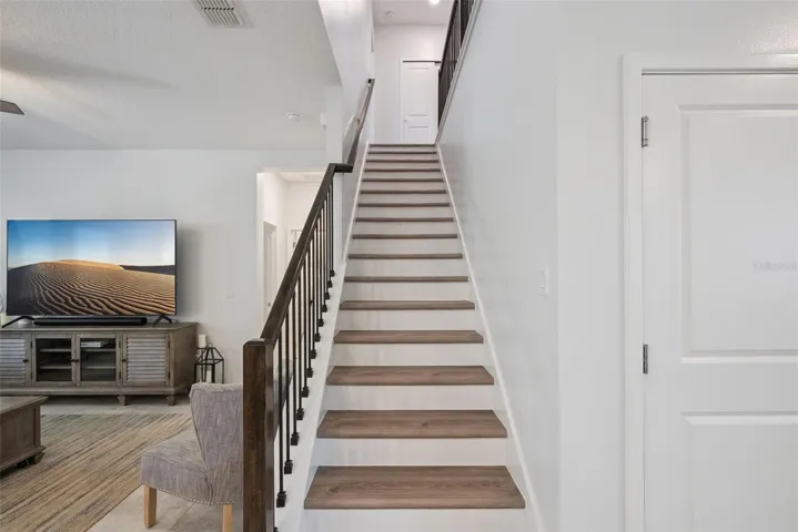 Garage entry next to stairs into foyer area