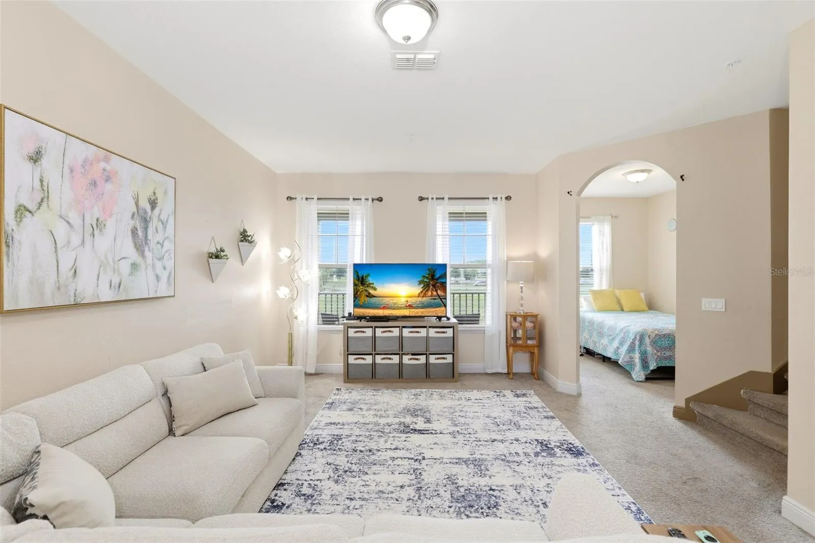 second level family room with bonus room used as additonal bedroom with door to outdoor front facing balcony