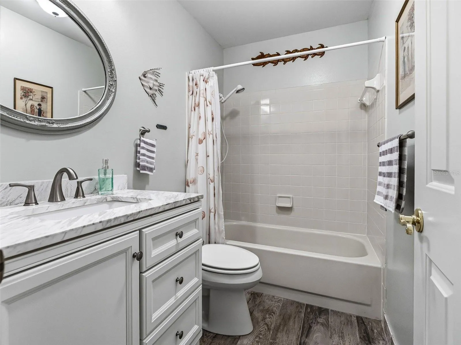 GUEST BATHROOM RENOVATED WITH NEW VANITY, MIRROR, FAUCET, TOILET AND FLOORING