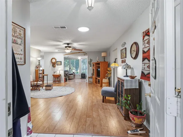 VIEW FROM FOYER TO OPEN LIVING ROOM WITH LUXURY FLOORING