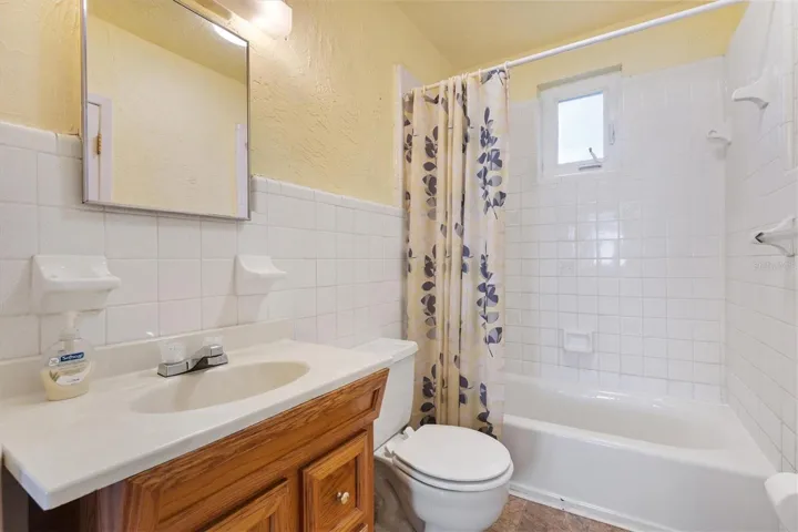BATHROOM WITH TILE SURROUND TUB