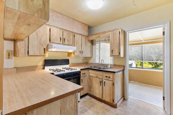 KITCHEN LOOKING TOWARDS FRONT PORCH