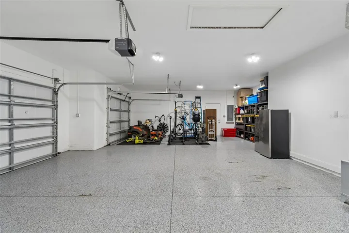 massive 3 car garage with epoxy floor and EV charger