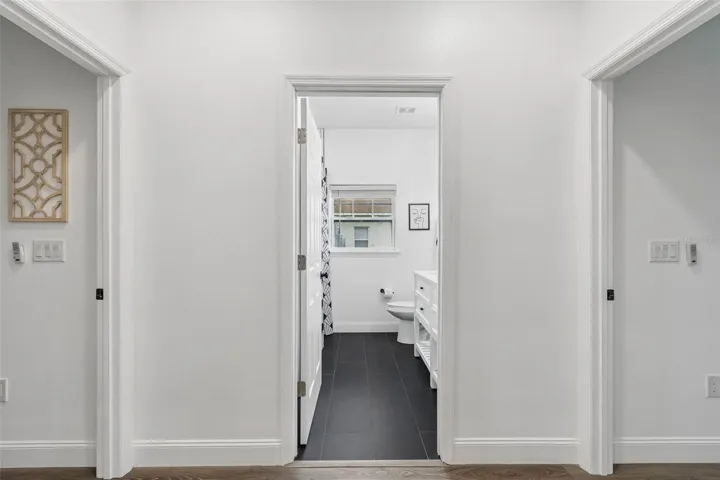 Pocket doors lead to 2 bedrooms with shared hall bath