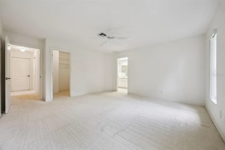 Primary retreat with ensuite bath, His & Her walk-in closets, jetted tub, separate tiled shower