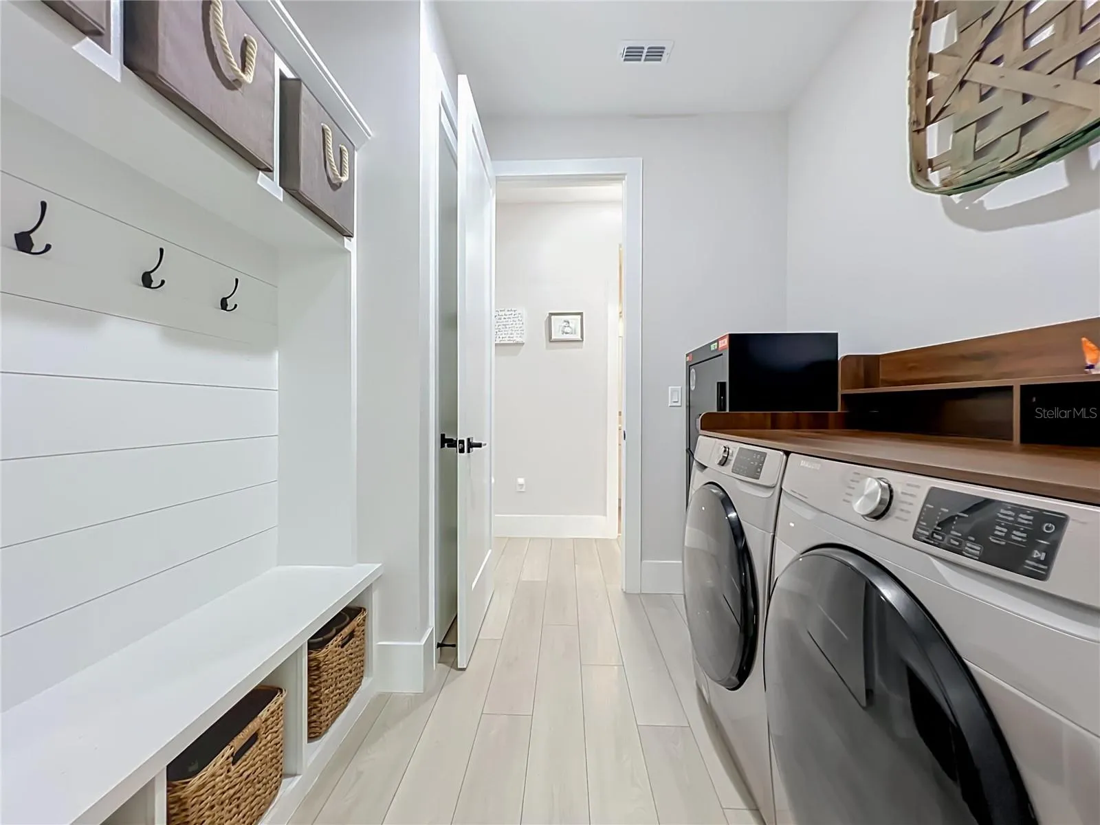 Laundry with custom built bench and storage.
