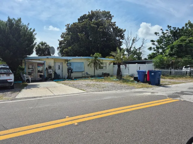 Front of property facing Flamingo Drive. Storefront is on the left and house on the right.