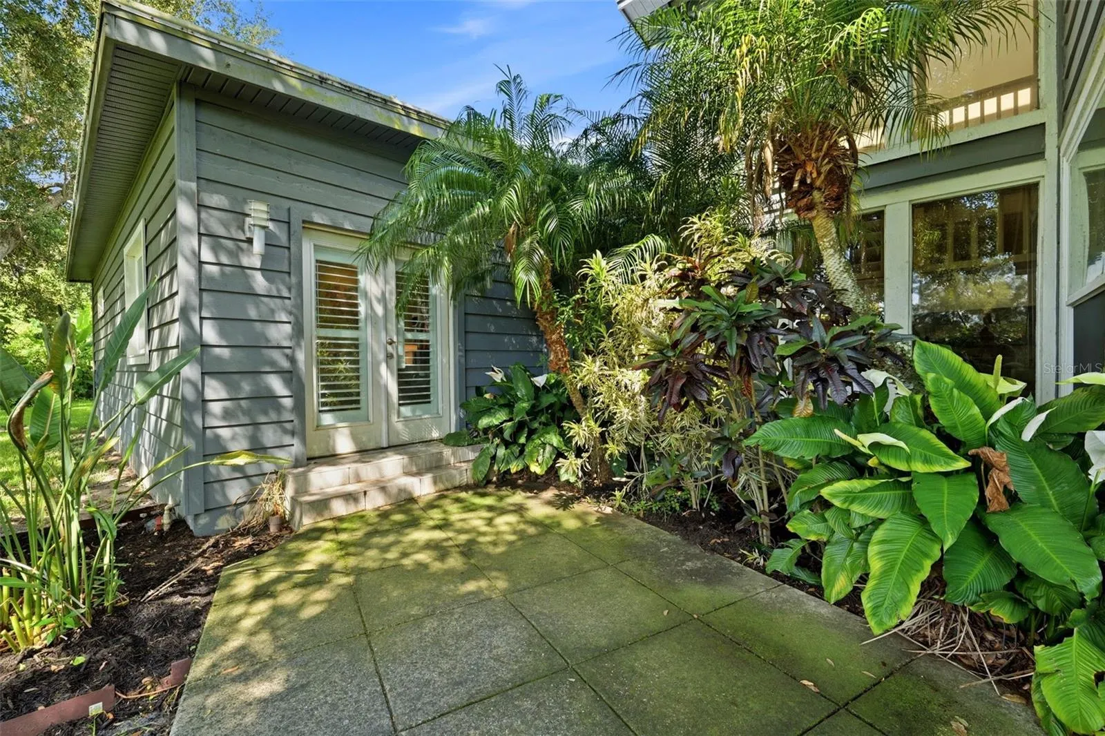 French doors lead from the downstairs primary suite out to the rear garden area