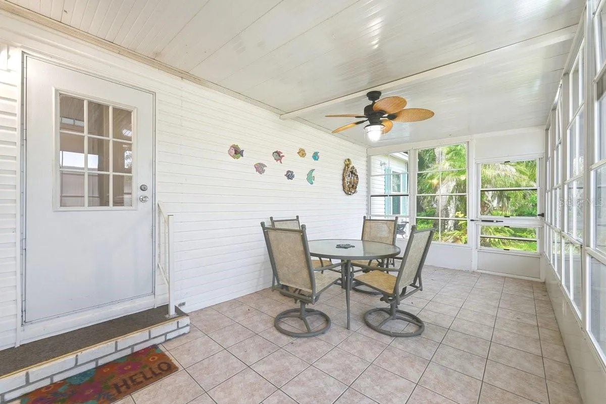 Florida Room off the Laundry Room. These Windows are vinyl and open/close. Room is Screened as well. You can put an A/C out here with the Vinyl Windows.