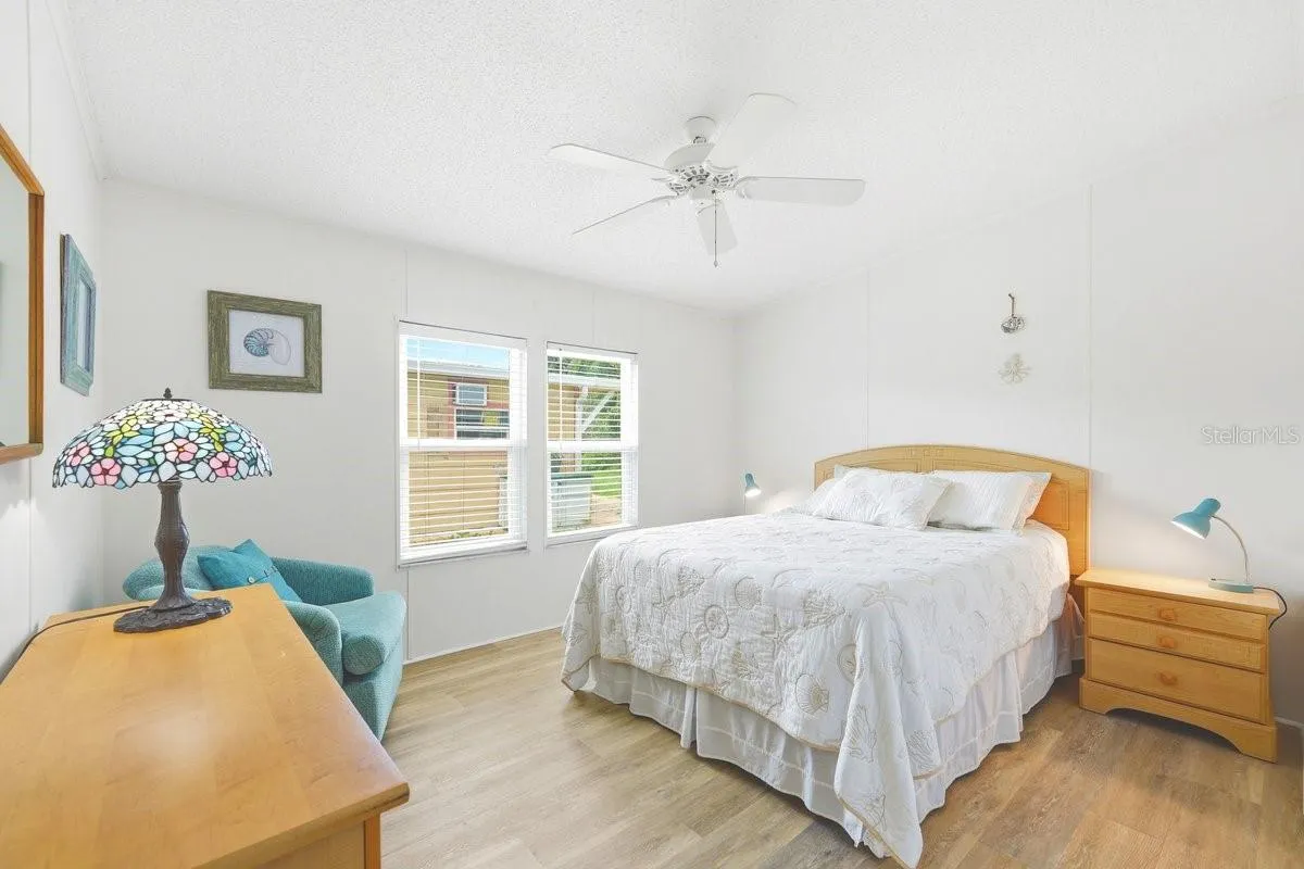 Bedroom 1 with Vinyl luxury Flooring, ceiling fan, and large closet
