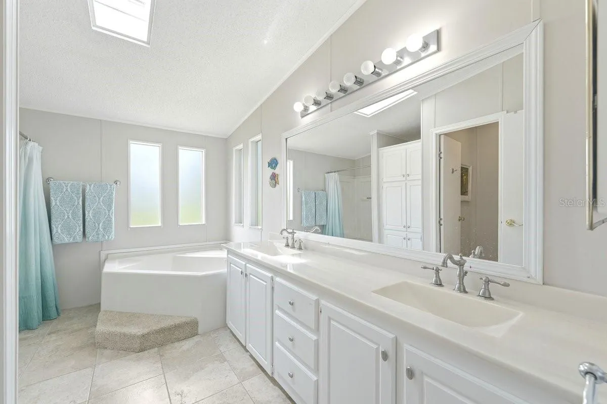 Owner's Bathroom with Dual Built in Sinks and Nickel Finishes.