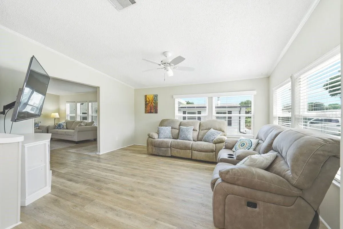 Family Room off the kitchen. Lots of windows. Blinds stay with the home. Ceiling Fan.