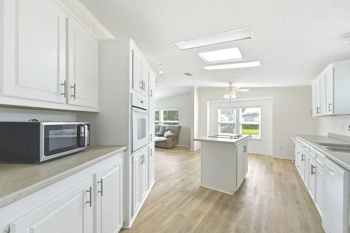 So many cabinets. Two windowsi in the background is eat in kitchen for your table.