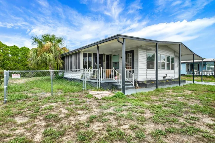 Screened lanai with open porch, fenced side yard