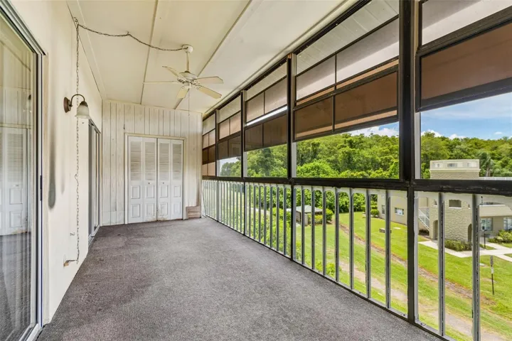 Florida Room with view toward storage closet and the 10th hold of OTOW golf course 10th tee.