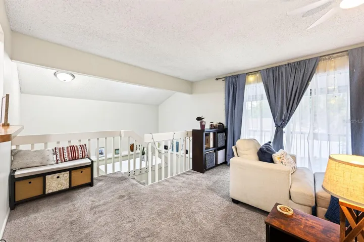 A light bright living space awaits at the top of the stairs from the foyer.