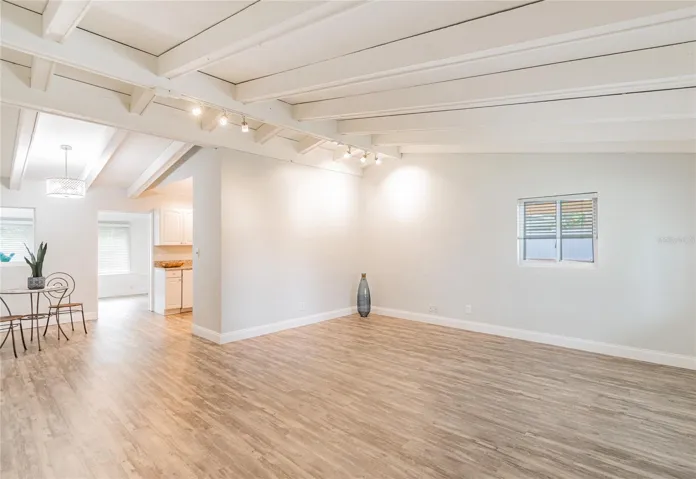 Living Room with luxury laminate flooring and cathedral ceilings