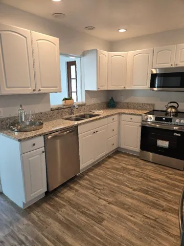 Kitchen with stylish granite counter tops and new dishwasher