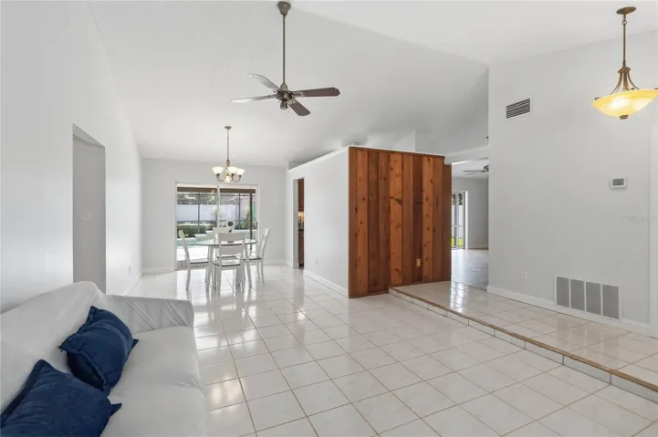 Large living and dining space with sliding doors to the lanae