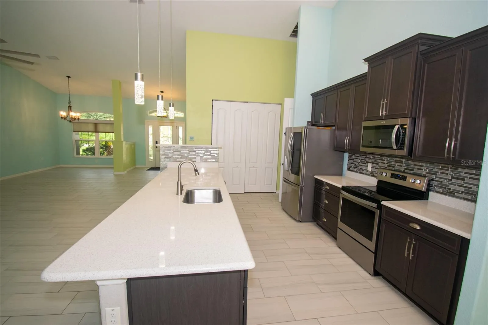 Spacious island kitchen featuring stainless steel appliances and a convenient walk-in pantry.