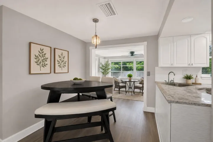Dining space with view of sunroom/virtually staged