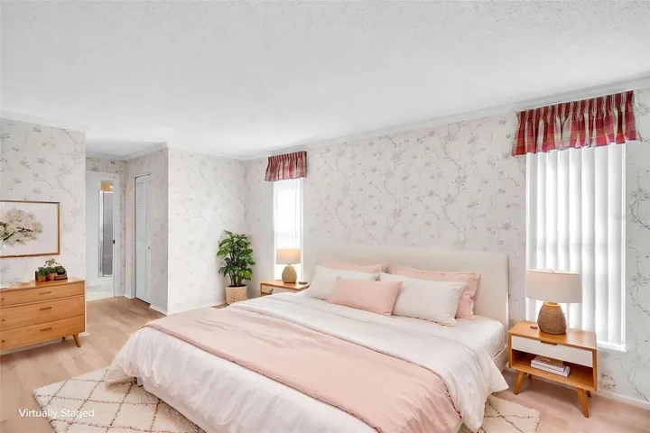 Spacious primary suite with TWO walk-in closets, and en-suite bath, and glass sliders out to the lanai~