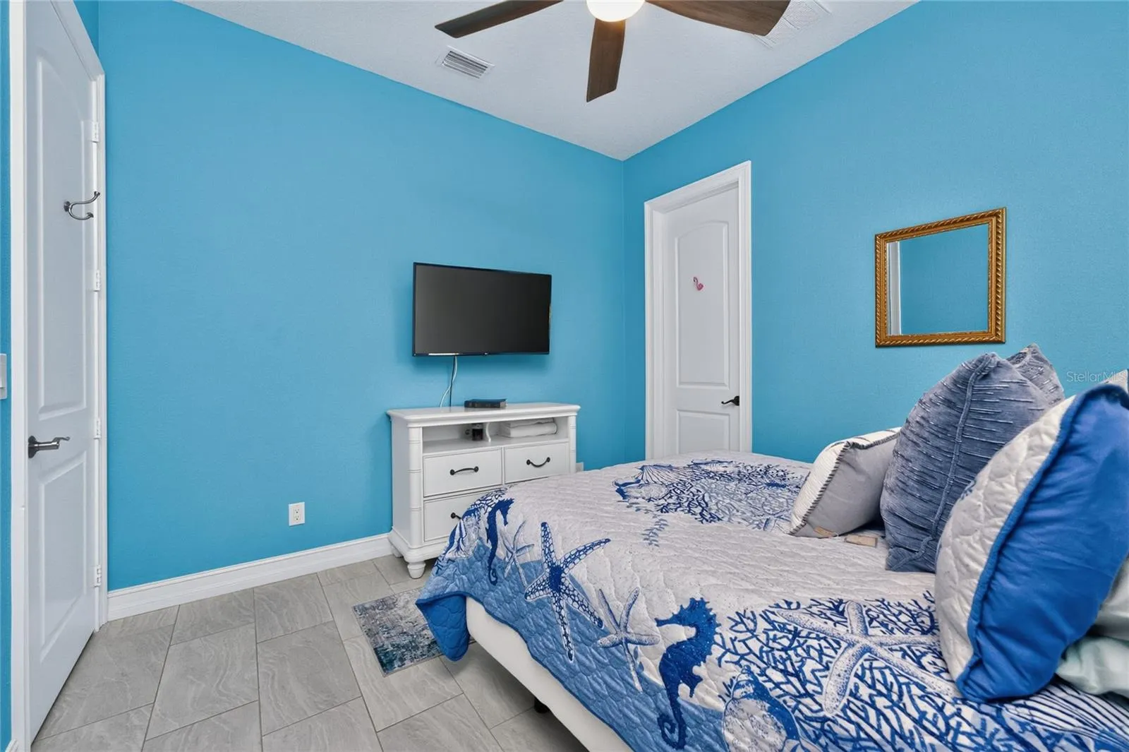 Guest bedroom has door on the right to the laundry roon