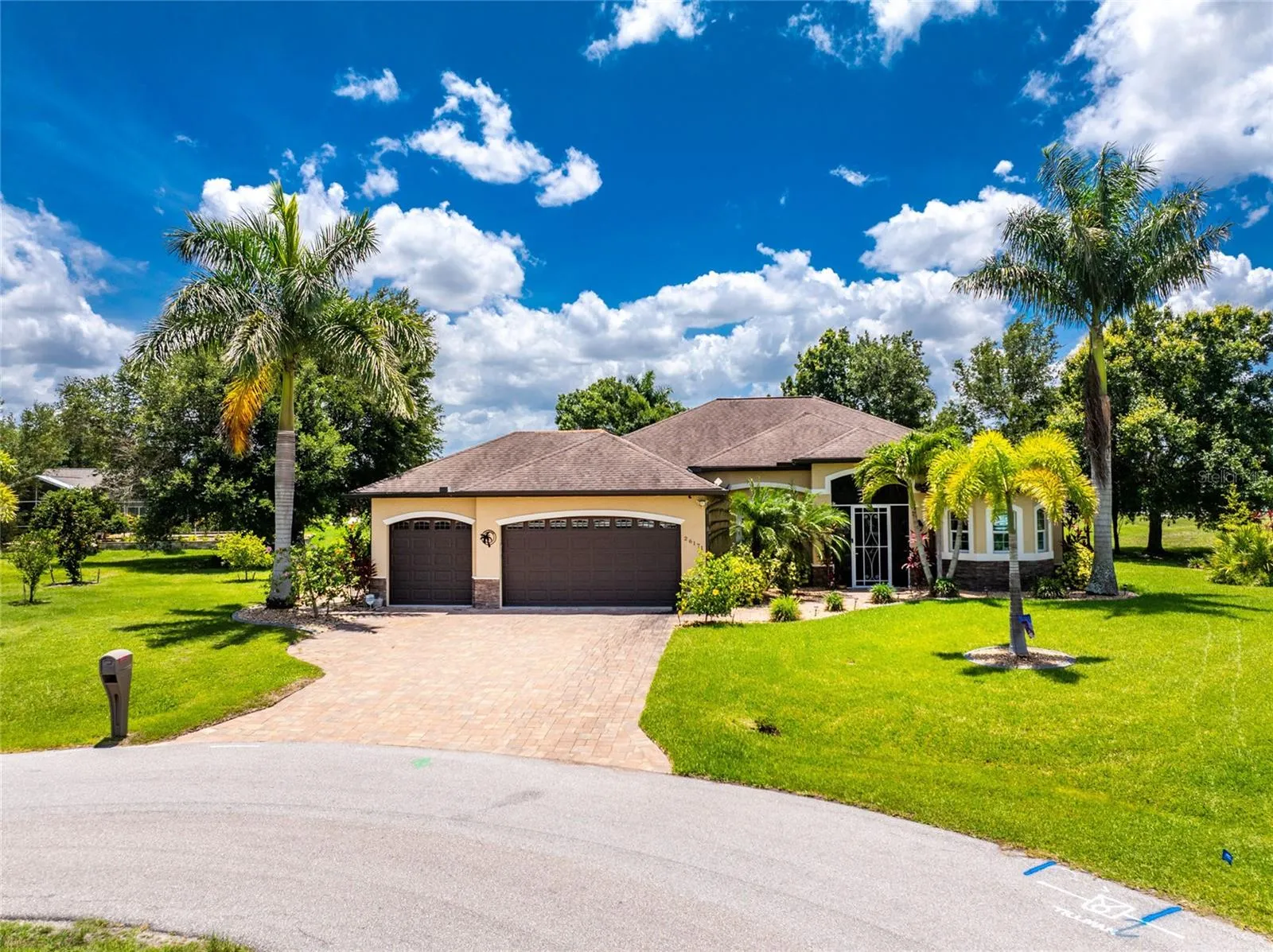 Three-car garage with oversized paver driveway and walkway