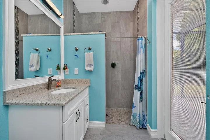 Ensuite bathroom with walk-in shower also serves as pool bath