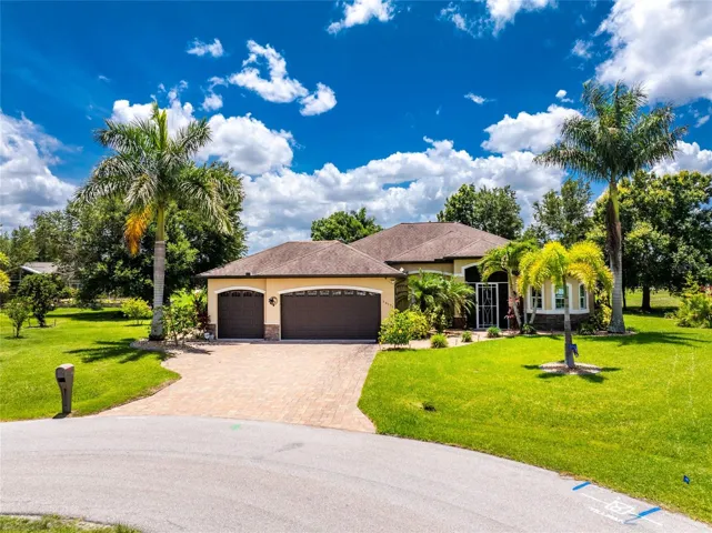 Three-car garage with oversized paver driveway and walkway