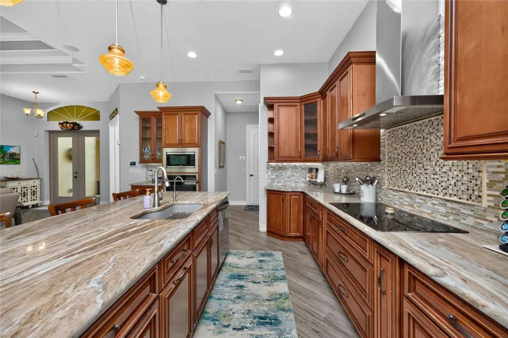 Stunning granite counters and glass mosaic tile backsplash