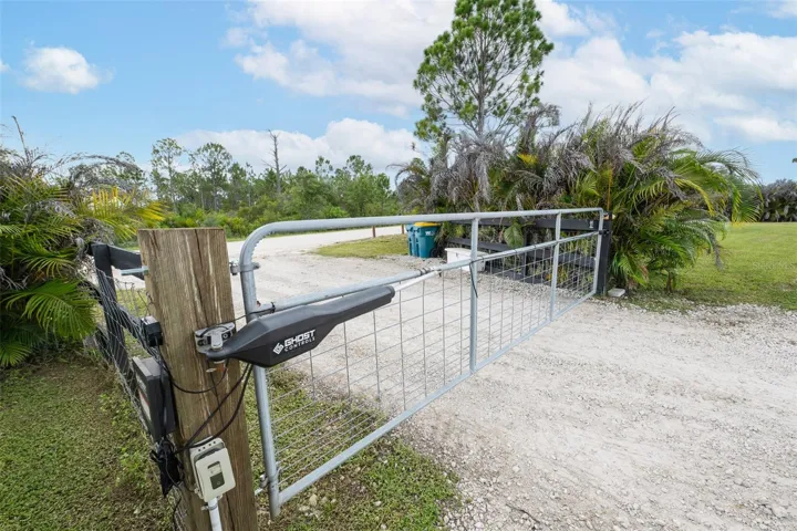 Detail view of the premium Ghost Controls automatic gate opener system. This high-quality addition provides effortless remote and keypad access to the property, perfect for entering seamlessly with trucks, trailers, boats, or RVs.