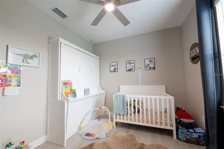 A closer look at the nursery highlighting the smart layout and space-saving options. This room easily accommodates full-sized furniture, cribs, or play areas while maintaining its sleek, contemporary feel with crisp baseboards and uniform flooring.