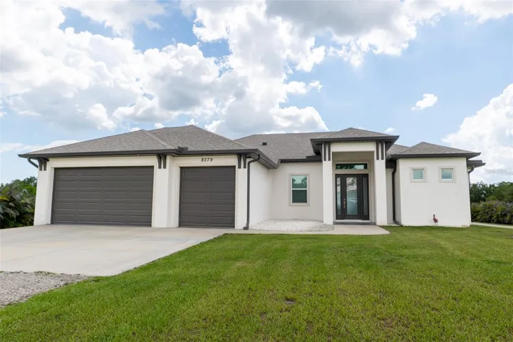 The crown jewel of the property! This breathtaking full front elevation showcases the custom luxury pool home in all its glory. Highlights include the magnificent stucco facade, architectural dark trim package, oversized multi-car garage, and sprawling manicured front lawn.