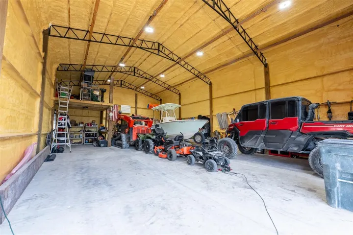 Incredible interior look at the ultimate detached garage! Fully spray-foam insulated for maximum climate control and energy efficiency, this massive commercial-grade space easily accommodates boats, side-by-sides, tractors, and heavy equipment with room to spare.
