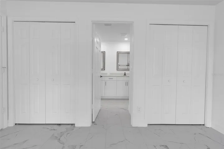 Master bedroom dual closets and entry to master bathroom