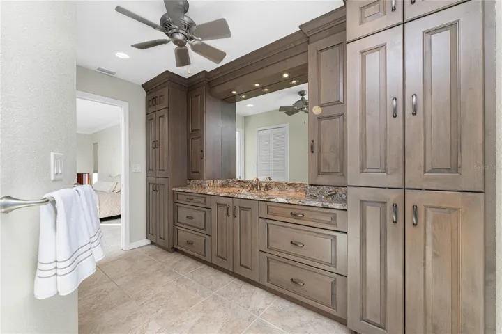 Beautiful custom solid wood cabinetry showcases Level 4 granite counter