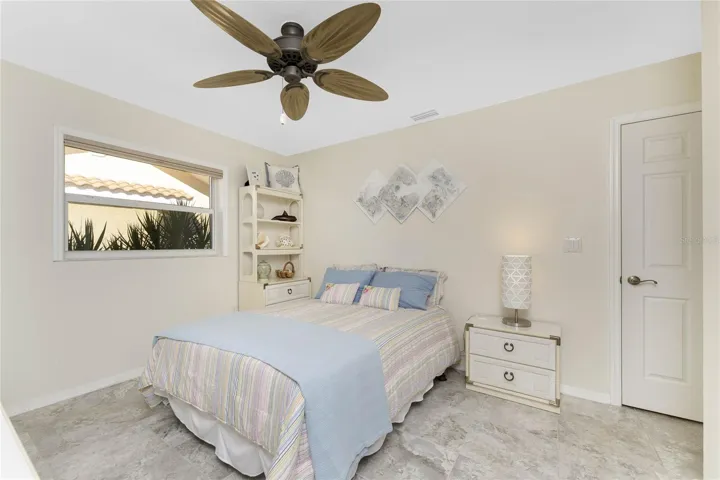 Welcoming second bedroom enhanced with porcelain tile