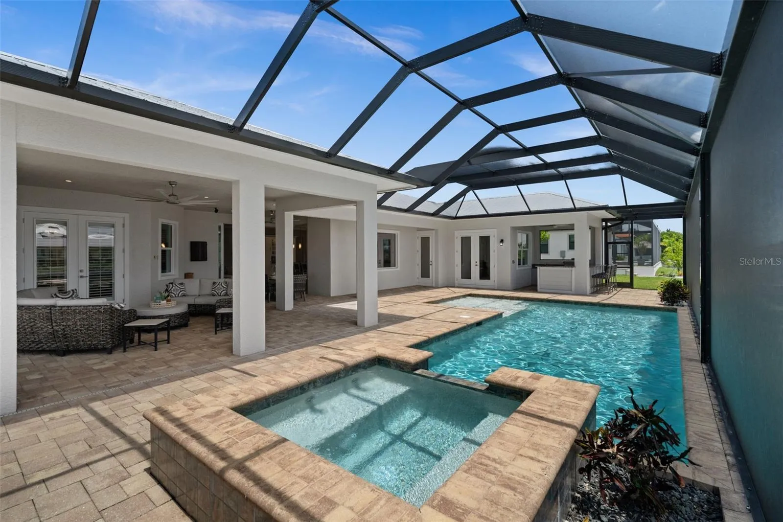 Large heated saltwater pool, spa, outdoor kitchen, huge lanai and lounging area